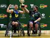 MELBOURNE, AUSTRALIA - NOVEMBER 05: Josh Christian of Tasmania and Tasmania Head Coach Joe Chivers hold the premiership cup aloft after winning the Division 2 Grand Final match between Tasmania and NSW/ACT during the 2023 Toyota AFL Wheelchair National Championships Grand Final Day at State Netball Hockey Centre on November 05, 2023 in Melbourne, Australia. (Photo by Josh Chadwick/AFL Photos/via Getty Images)