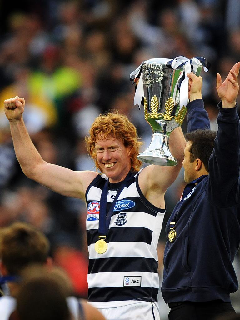 Geelong captain Cameron Ling and coach Chris Scott hold the 2011 premiership cup. Picture: AAP Image/Joe Castro.