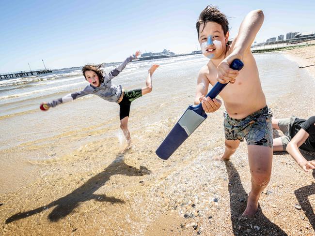 The weather is finally warming and sunny days are predicted for Christmas. Ella Brown (8), Harry Brown (11) and Alex Brown (13) get some beach cricket in at Port Melbourne Beach. Picture: Tony Gough