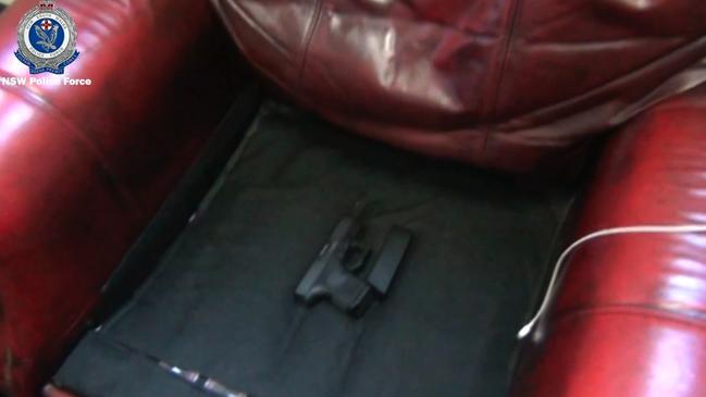 The Glock allegedly found hidden under a lounge chair cushion by Strike Force Raptor investigators. Picture: NSW Media