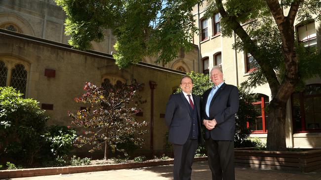 Principal Joseph Favrin and Father Bill Uren SJ in front of where the missing bell would have stood at Loyola College. Picture: Hamish Blair