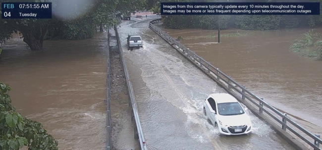 Flood cams capture cars driving over Ryan Weare Park bridge as water levels rise. Picture: Supplied.