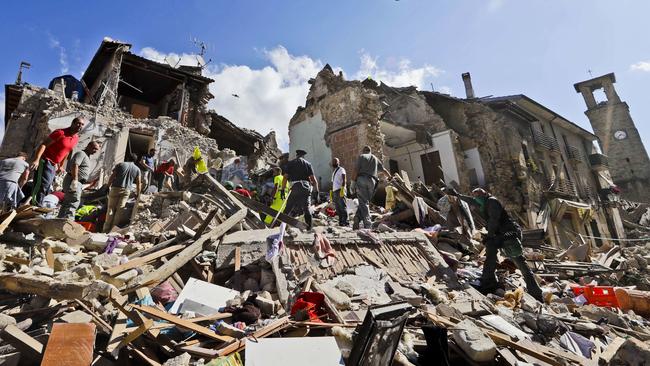 Rescuers search through debris in Amatrice. Picture: AP/Alessandra Tarantino