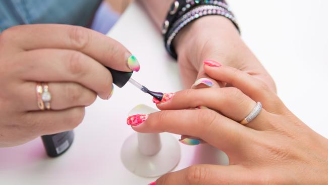 Generic pic of woman in salon receiving manicure by nail technician. Pic: iStock