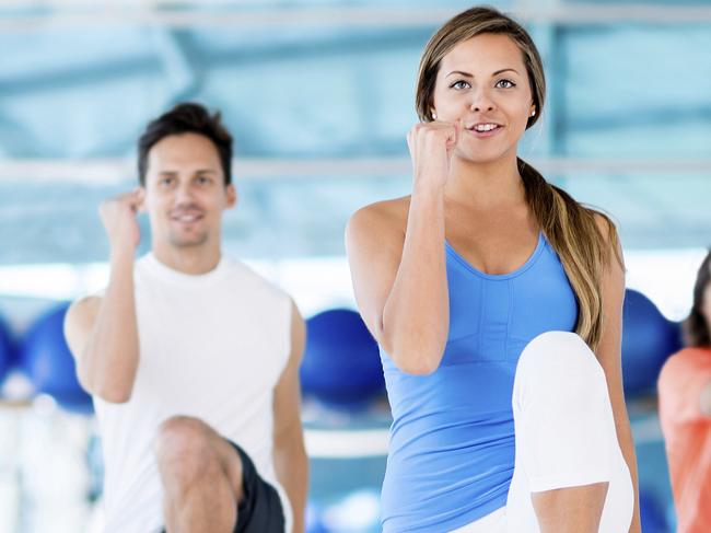 Group of people exercising at the gym in an aerobics class