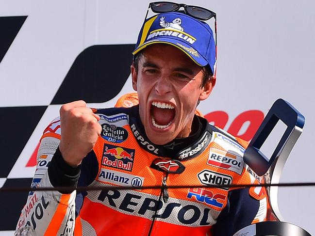 Race winner Repsol Honda Team Spanish rider, Marc Marquez celebrates on the podium following the San Marino MotoGP Grand Prix race at the Misano World Circuit Marco Simoncelli on September 15, 2019. (Photo by Marco Bertorello / AFP)