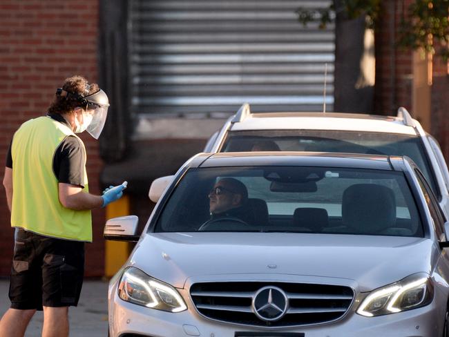 Visitors, contractors and staff have their temperatures taken at Cedar Meats after a COVID-19 cluster forced the processing centre to temporarily close. Picture: Andrew Henshaw