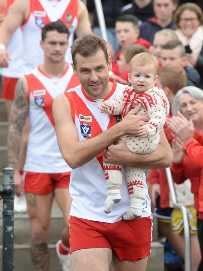 Luke Van Raay runs out with his daughter Elle. Picture: Chris Eastman