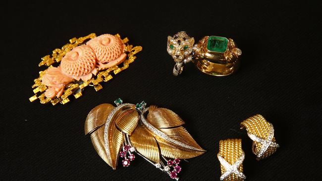 Clockwise from Top left: Coral brooch, diamond, emerald and enamel ring by Piajet and a diamond and emerald ring from Tony White, Tiffany diamond earrings by Schlumberger and diamond and gem set leaf brooch. Picture: John Appleyard