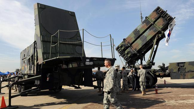 A US soldier walks past the launcher of a Patriot missile PAC-3 system at the US airbase in Osan, south of Seoul. Picture: AFP