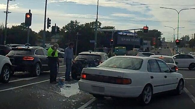 The hatchback driver examines the damage. Picture: Keith Woods.