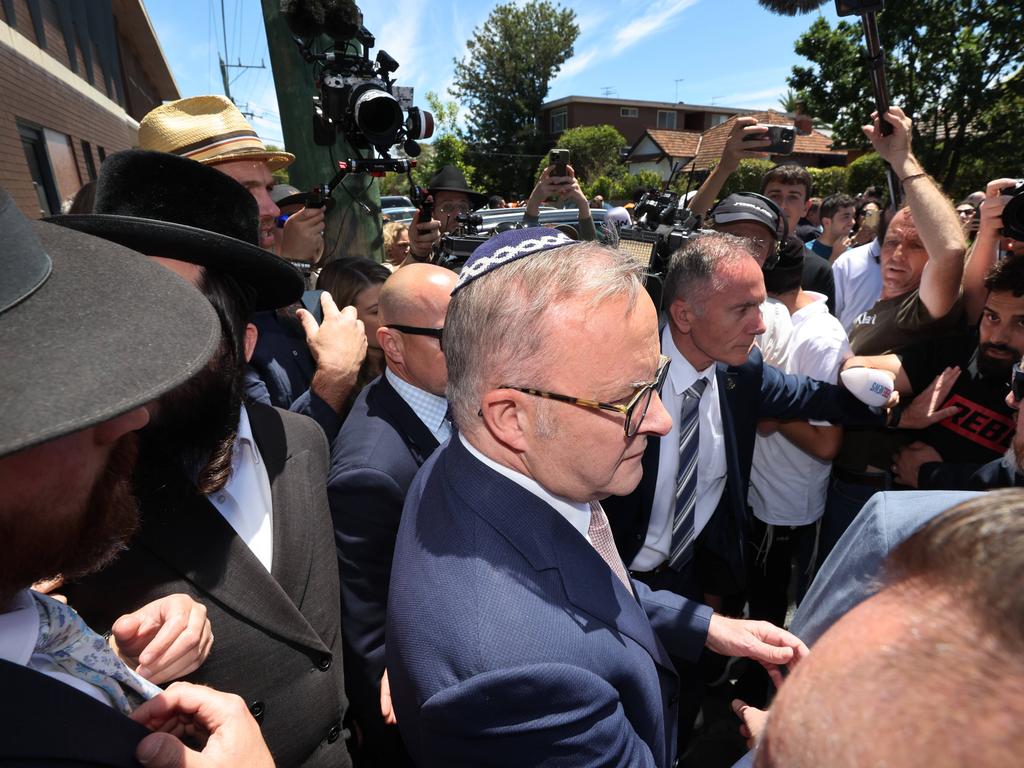 The Prime Minister’s staff try to clear a path among the crowd. Picture: David Caird