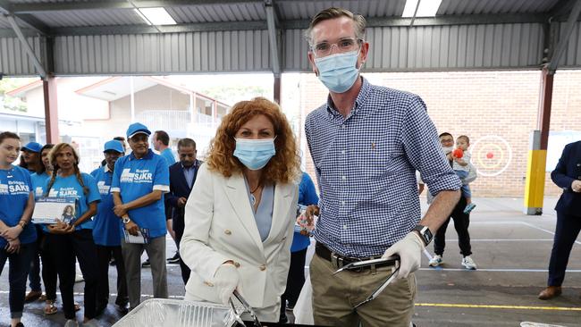 NSW Premier Dominic Perrottet and Bridget Sakr helping out on the BBQ during the Strathfield by-election. Picture: Tim Hunter