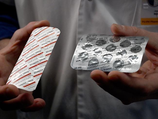 (FILES) In this file photo taken on February 26, 2020 a medical staff shows at the IHU Mediterranee Infection Institute in Marseille, packets of a Nivaquine, tablets containing chloroquine and Plaqueril, tablets containing hydroxychloroquine, drugs that has shown signs of effectiveness against coronavirus. - On March 29, 2020,a limited emergency-use authorization for two antimalarial drugs touted as game-changers by President Donald Trump has been issued by the US Food and Drug Administration to treat coronavirus patients. In a statement published Sunday, the US Department of Health and Human Services detailed recent donations of medicine to a national stockpile -- including chloroquine and hydroxychloroquine, both being investigated as potential COVID-19 treatments. (Photo by GERARD JULIEN / AFP)