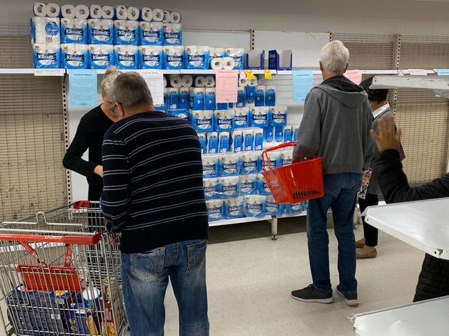 People are pictured as they scramble for toilet paper and other long-life goods at Coles in Chatswood in the midst of coronavirus fuelled fears. Picture: Rohan Kelly