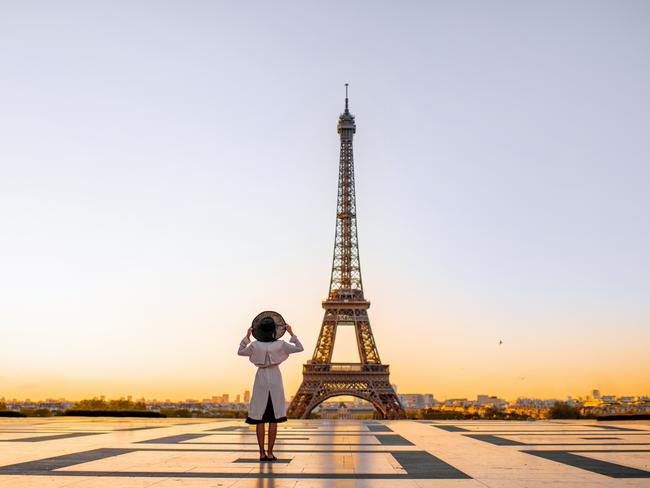 Famous square with great view on the Eiffel tower and woman standing back enjoying the view in Paris