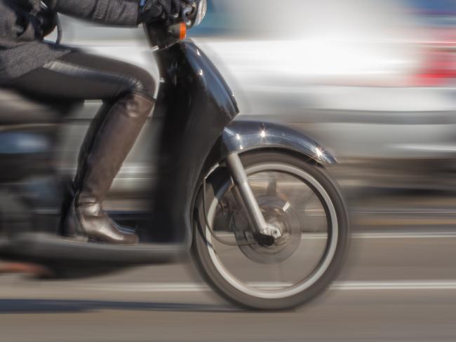 Scooter in blurred motion. City atmosphere.