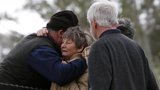 A woman believed to be the wife of the man killed at Tungkillo is comforted by neighbours after the tragedy. Picture: Simon Cross