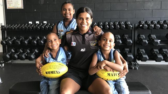 Machaelia Roberts with her daughter Elaine, 7, and five-year-old twin sons, Rex and Raiden. Picture: AFLNT Media