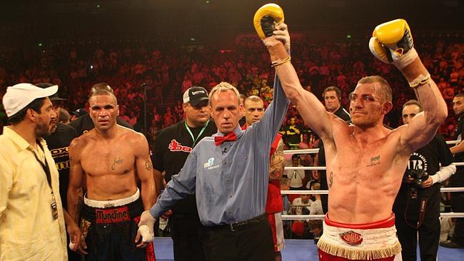 Anthony Mundine and then manager Khoder Nasser in shock as referee Les Fear lifts the arm of winner Garth Wood in the 2010 Mundine v Wood fight in Sydney. 