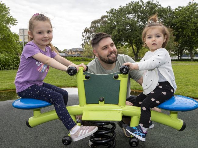 7/10/2022: Kane McParland with daughters Ayla, 4.5, Navy, 16 months. Kane works for Sydney Trains as a Fleet Operations Controller and lives in Harrington Park. He is in the 120-180k tax bracket. Picture: Liam Mendes / The Australian