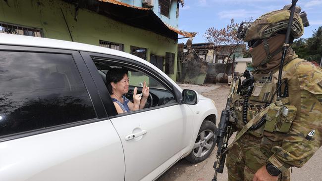 A local Chinese women thanks Australian soldiers for coming to the Solomon Islands. Picture: Gary Ramage.