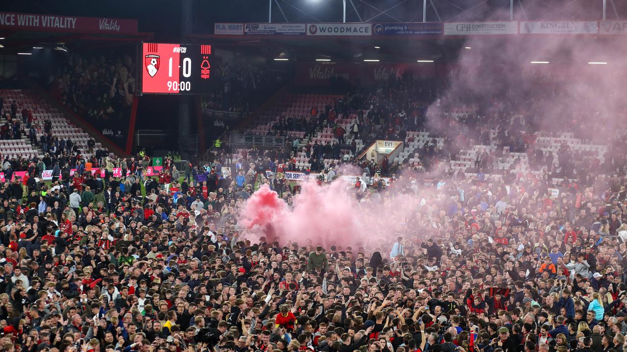 Fans invade the pitch and light flares at full-time. (Photo by Mark Leech/Offside/Offside via Getty Images)