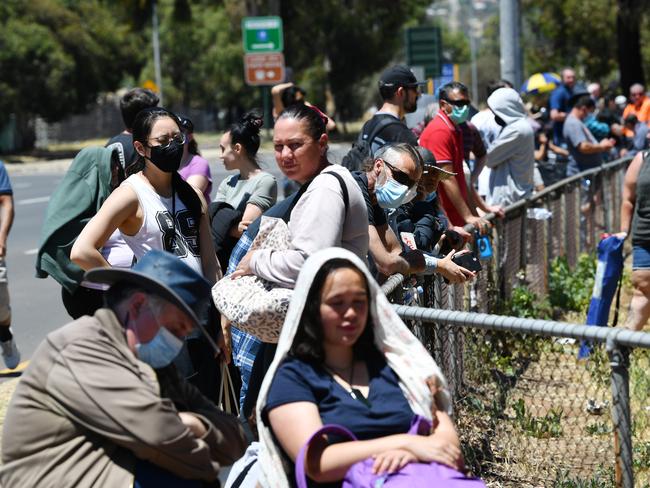 ADELAIDE, AUSTRALIA - NOVEMBER 17: People are seen queuing up at the Parafield Gardens COVID testing centre on November 17, 2020 in Adelaide, Australia. South Australia has reintroduced COVID-19 restrictions in response to a growing coronavirus cluster in Adelaide's northern suburbs. As of midnight on Monday, restrictions have been reintroduced across South Australia including the closure of gyms, play cafes and trampoline parks and the cancellation of indoor and outdoor community sport and trainings. Pubs, clubs and restaurants now have a capped capacity of 100 people per venue with one person per four square metres allowed and no stand-up consumption of alcohol while private gatherings are capped at 10 people per residence. Masks are now mandatory for aged care facilities, with visitors capped at two per day.  (Photo by David Mariuz/Getty Images)