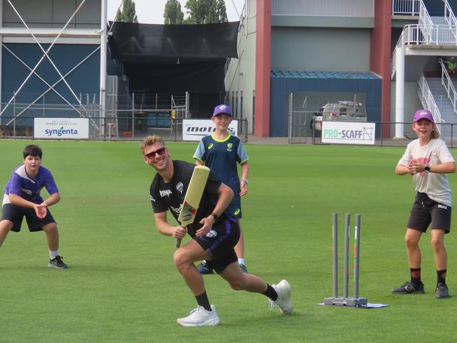 Hurricanes fans watch on as player Riley Meredith bats at Tuesday's fan day in Launceston. Picture: Jon Tuxworth