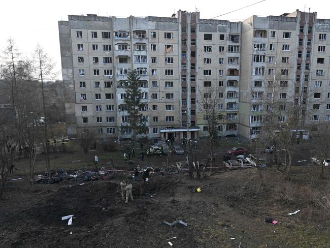 Residents inspect a damaged building and its surrounding after a missile attack in Lviv. Picture: AFP