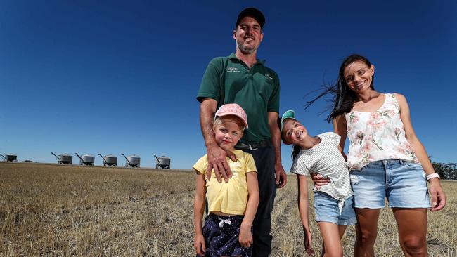 Russell Burges and wife Rebekah with their children Tayla and Rylie on their barley farm at Meckering, 130km east of Perth. Picture: Colin Murty