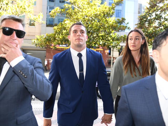 Adam Elliott (centre) arrives at the Downing Centre Court. Picture: Dean Lewins