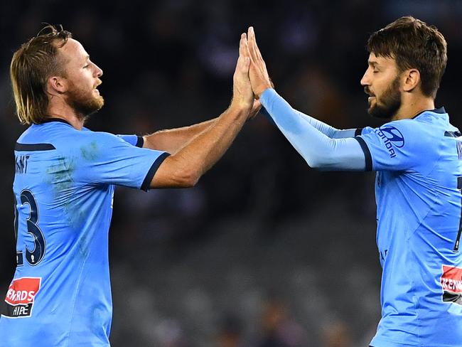 MELBOURNE, AUSTRALIA - MARCH 07: Milos Ninkovic of Sydney FC is congratulated by Ryan Grant after scoring a goal during the round 22 A-League match between the Melbourne Victory and Sydney FC at Marvel Stadium on March 07, 2020 in Melbourne, Australia. (Photo by Quinn Rooney/Getty Images)