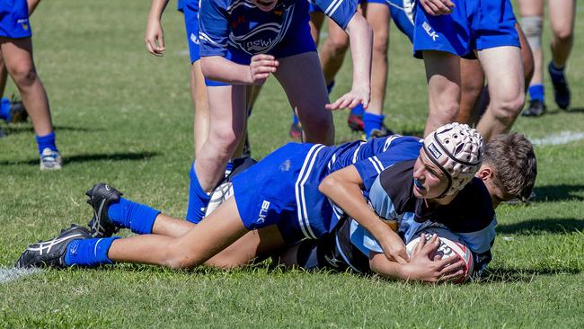 Day One of King of the Country rugby tournament at James Overell Park, Southport. Maroochydore Swans U14s' ( big stripes - blue) in action against USQ Saints U14s' (darker blue small stripes). Maroochydore Swans U14s Jarvis Wood scoring a try . Picture: Jerad Williams