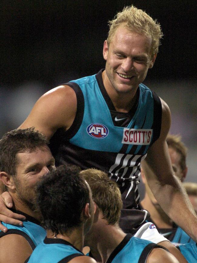 Footballer Chad Cornes being carried by teammates after a win in 2004. Picture: Jody D'Arcy