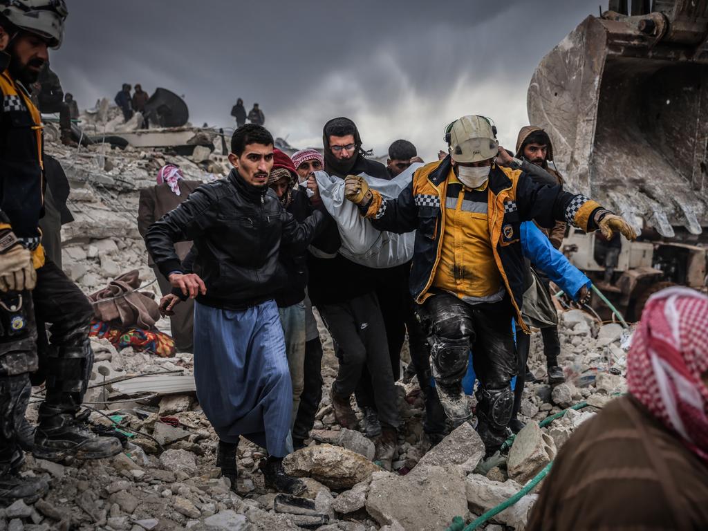 Syrian civilians and members of the White Helmets conduct search and rescue operations in the rubble of a collapsed building. Picture: Getty