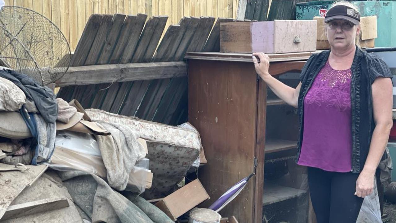 Machans Beach resident Rosita Norman begins the mammoth task of cleaning up a flood-inundated home. Picture: Bronwyn Farr