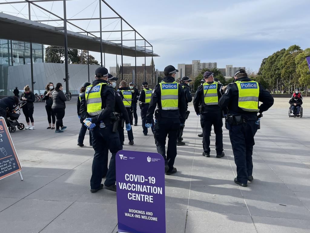 Police outside the Royal Exhibition Building vaccination hub in Carlton ahead of planned protest action. Picture: Brianna Travers