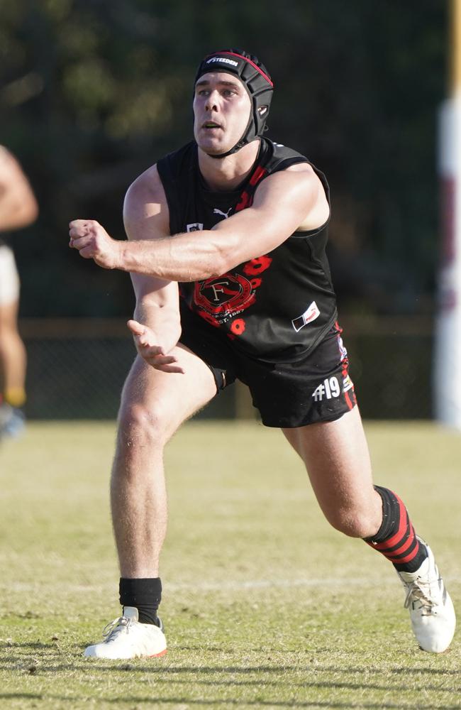 Harry Prior fires out a handball for the Bombers. Picture: Valeriu Campan.