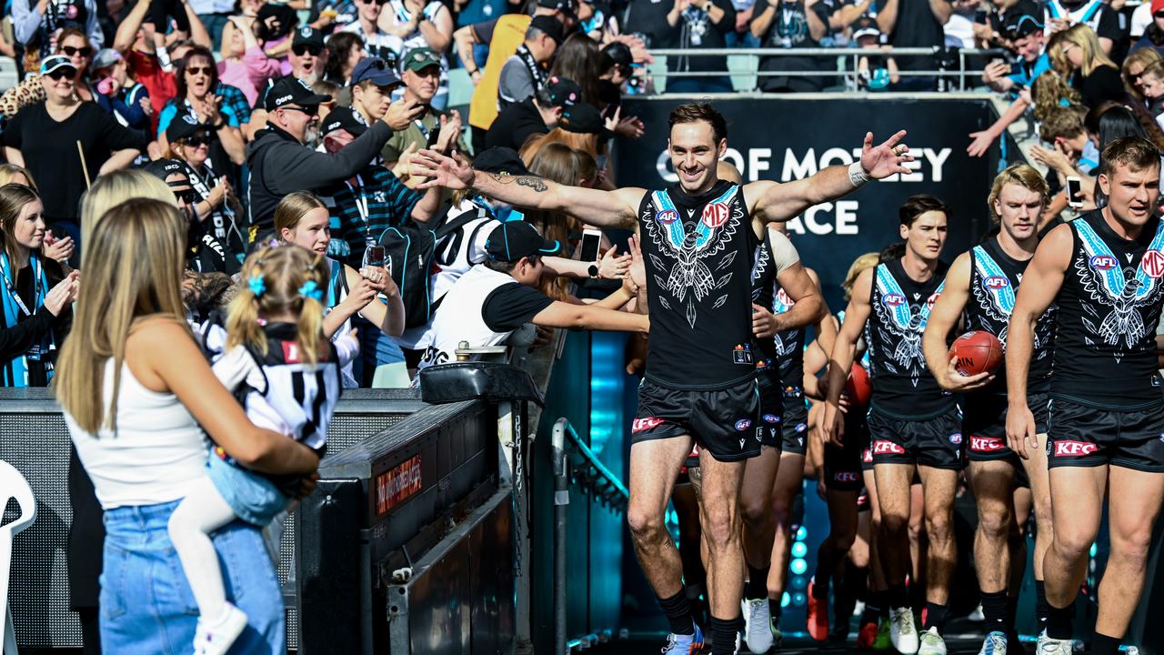 Jeremy Finlayson meets wife Kellie and daughter Sophia before running through the banner at Adelaide Oval. Picture: Mark Brake/Getty Images