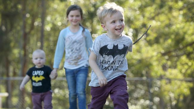 Siblings Ragnar, Serenity and Gabriel Leach exploring Underwood Park. (AAP Image/Jono Searle)