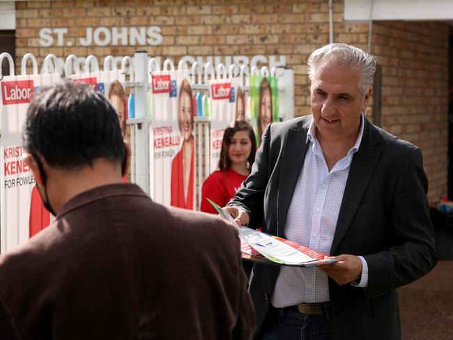 Frank Carbone handing out how to vote cards at pre polling at St Johns Park Anglican Church in Sydney's Cabramatta for the 2022 federal election Picture: Damian Shaw