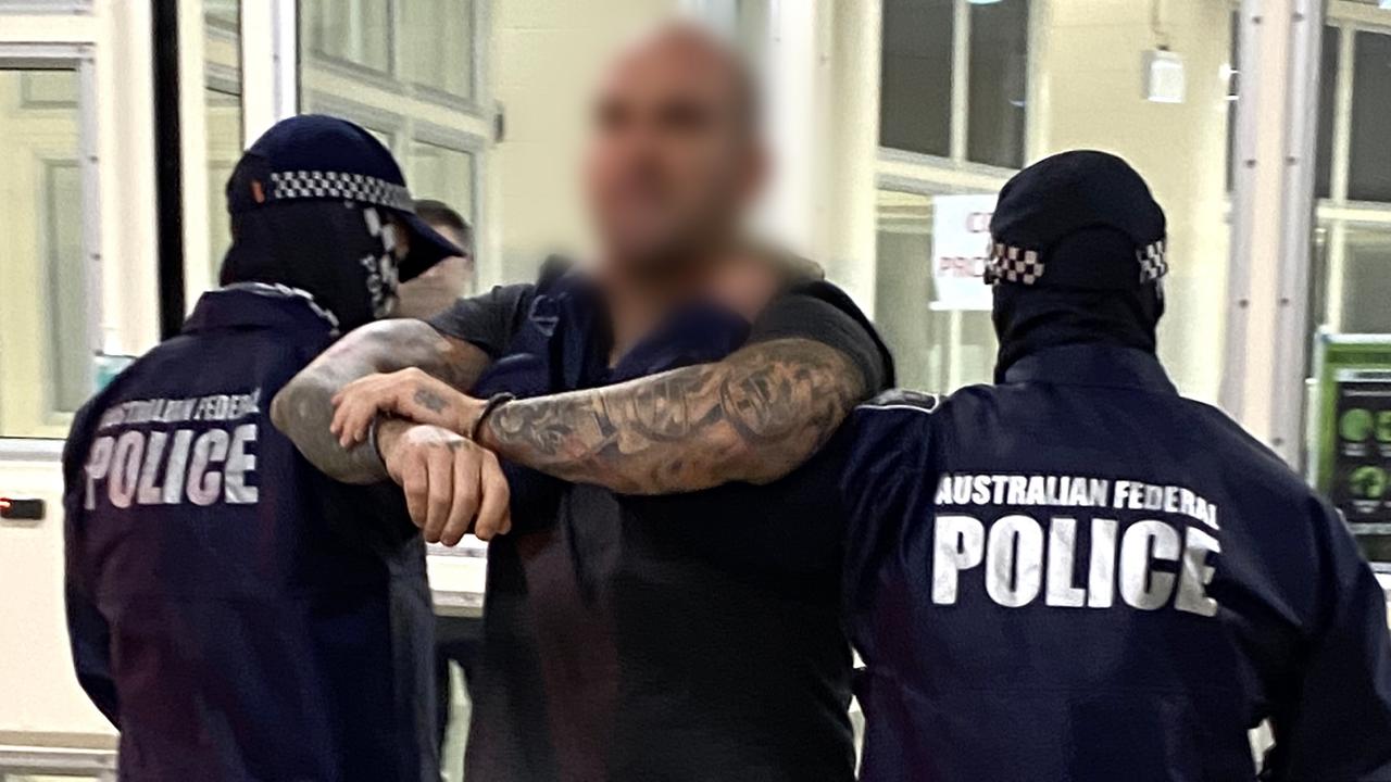 AFP officers hold Buddle after he was arrested in Darwin. Picture: AFP