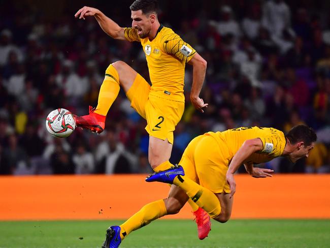 Australia's defender Milos Degenek (background) controls the ball during the 2019 AFC Asian Cup quarter-final football match between UAE and Australia at Hazaa bin Zayed Stadium in Al-Ain on January 25, 2019. (Photo by Giuseppe CACACE / AFP)