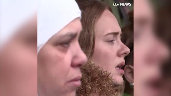 Adele sings along to 'Lean on Me' as she stands with the Grenfell families on the first anniversary of the fire.