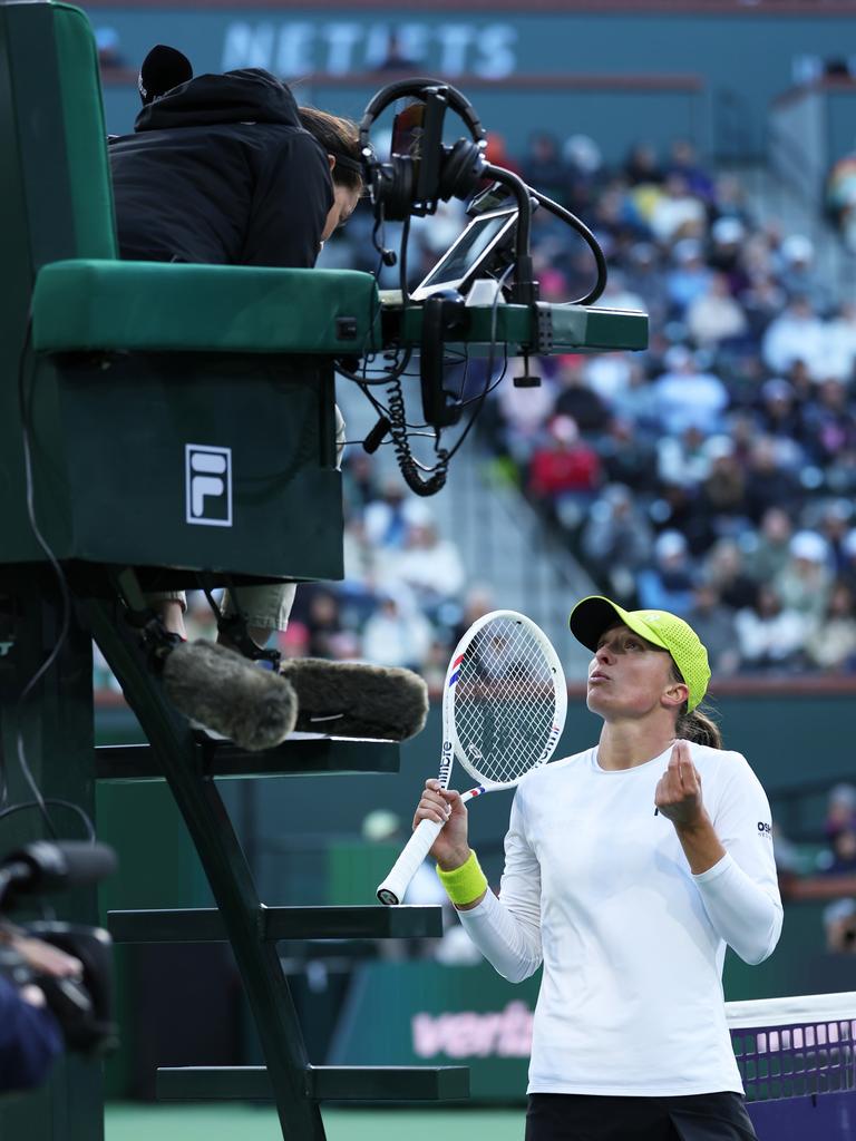 Iga Swiatek of Poland shows her frustration to the umpire. Photo by Clive Brunskill/Getty Images.