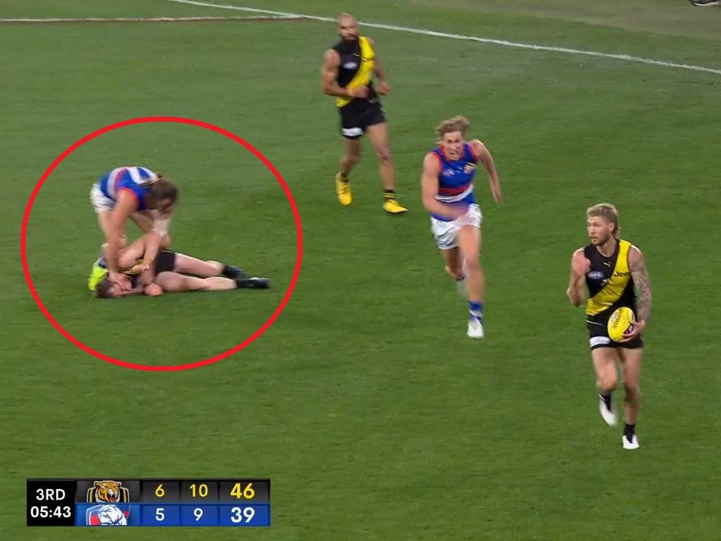 Josh Bruce rubs Dylan Grimes' head into the ground.