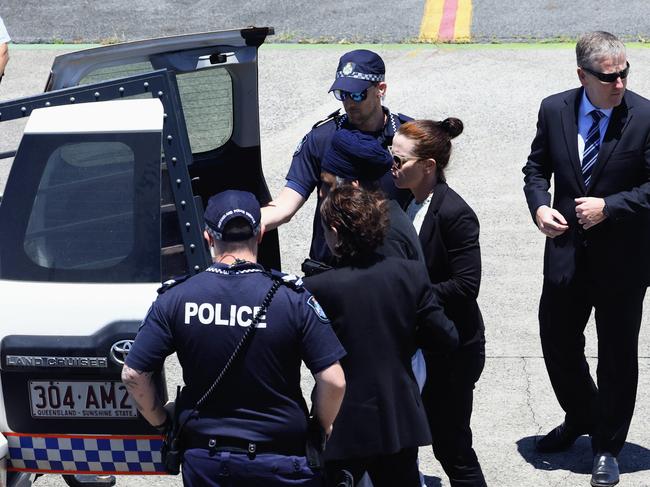 Queensland Police officers and detectives escort Rajwinder Singh from a chartered jet to a waiting police car at Cairns Airport after being extradited from New Delhi to Cairns via Melbourne. Picture: Brendan Radke