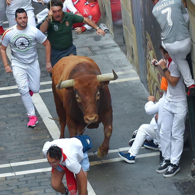 Participants try to avoid a bull at San Fermin festival in 2019. Picture: Ander Gillenea/AFP