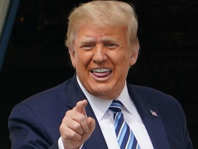 TOPSHOT - US President Donald Trump greets supporters after speaking about law and order from the South Portico of the White House in Washington, DC, on October 10, 2020. - Trump spoke publicly for the first time since testing positive for Covid-19, as he prepares a rapid return to the campaign trail just three weeks before the election. (Photo by MANDEL NGAN / AFP)